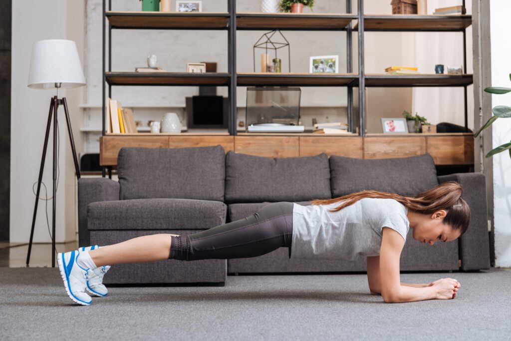 Girl doing the Plank exercise at home 
