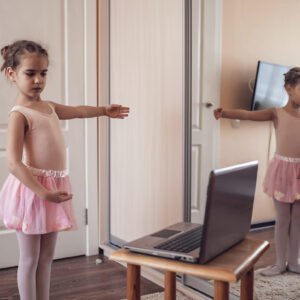 Student of Online ballet classes practicing in front of laptop