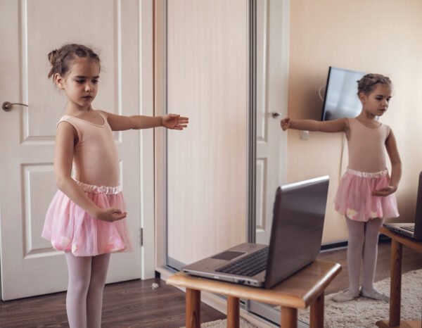 Student of Online ballet classes practicing in front of laptop